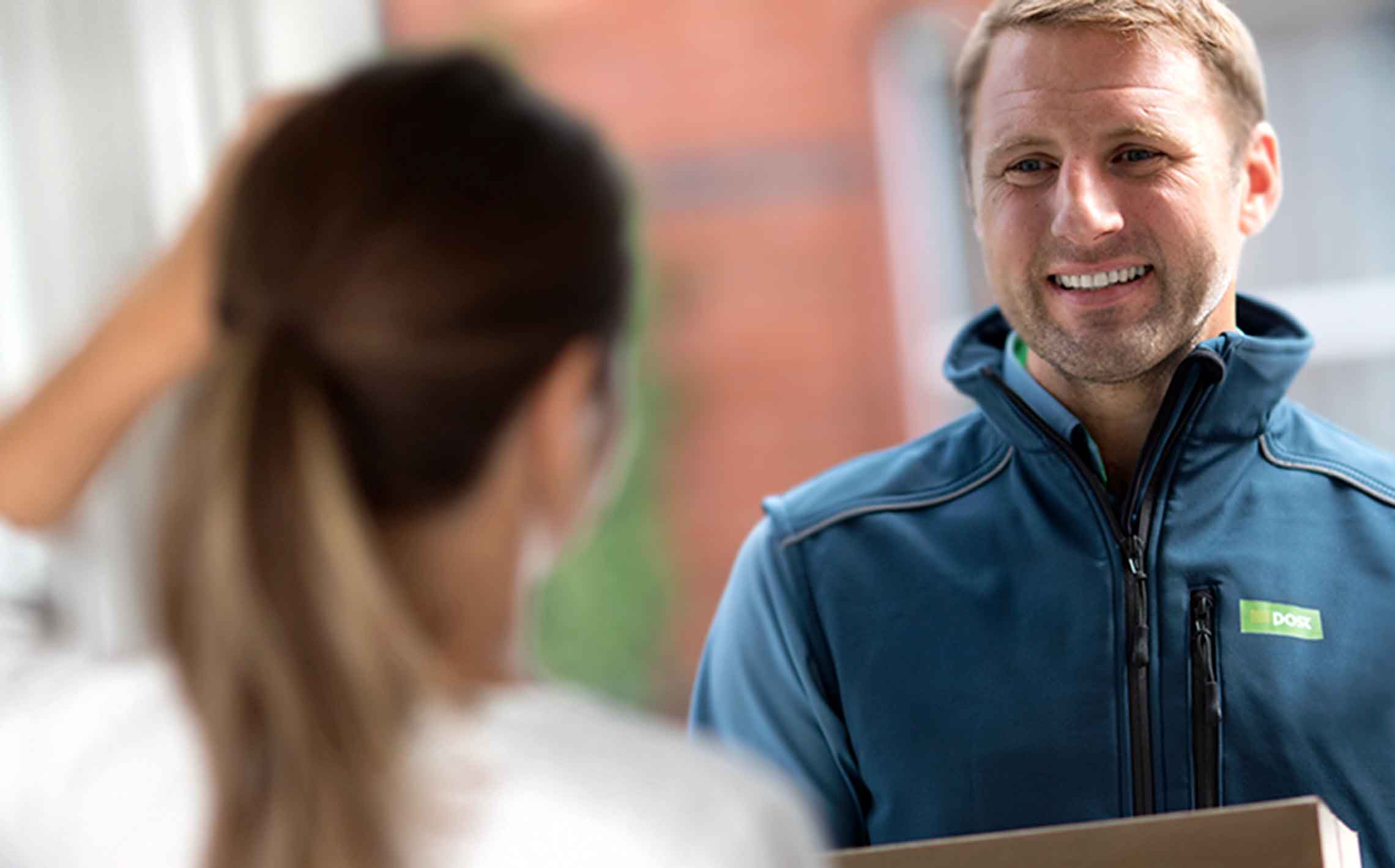 Postman delivers post to woman at house